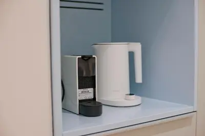 a counter with two appliances sitting on a shelf at Radiant Voula Studio, a stone's throw from the Sea in Athens