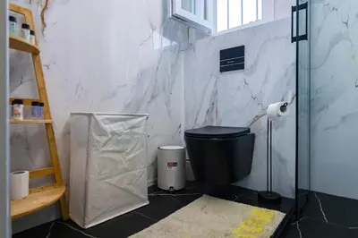 a bathroom with a toilet and a glass shower at Noir Luxury 1 bedroom Atelier in Athens
