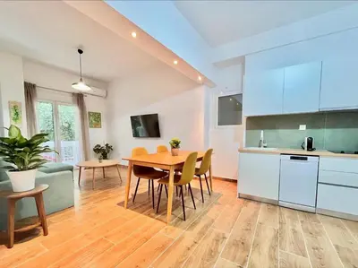 a kitchen and dining room with a table and chairs at Earthy Retreat in Central Athens Fully renovated in Athens