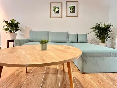 a living room with a blue couch and a table at Earthy Retreat in Central Athens Fully renovated in Athens