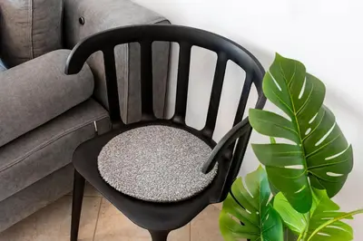 a black chair sitting next to a couch at Elysian Lycabettus - Panorama in Athens