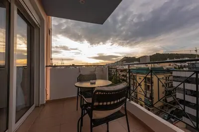 a balcony with a table and chairs on a balcony at Elysian Lycabettus - Panorama in Athens