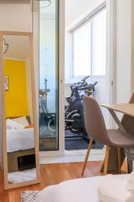 a room with a mirror and a bike in a room at Aiolos Alimos Riviera super luxury Grand suite with gym in Athens