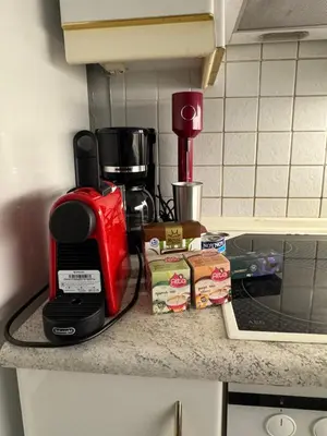 a kitchen counter with a coffee maker on a counter at Aiolos Alimos Riviera super luxury Grand suite with gym in Athens