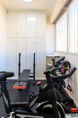 a gym with a row of bikes in a room at Aiolos Alimos Riviera super luxury Grand suite with gym in Athens