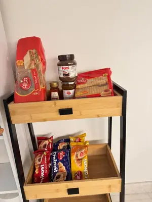 a shelf with food and other food items on it at Aiolos Alimos Riviera super luxury Grand suite with gym in Athens