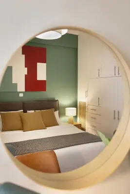 a bedroom with a bed and a mirror at Eclectic Studio near Kallimarmaro in Athens