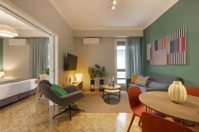 a living room with a bed and a table at Eclectic Studio near Kallimarmaro in Athens