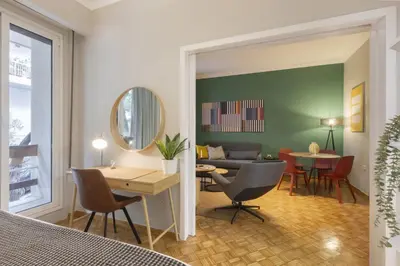 a living room with a couch and a table at Eclectic Studio near Kallimarmaro in Athens