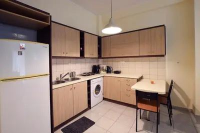 a kitchen with a white refrigerator and a table at Celia's in Athens