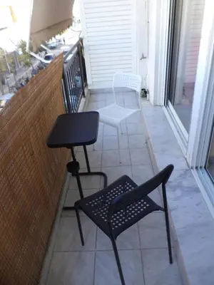 a balcony with two chairs and a table at Celia's in Athens