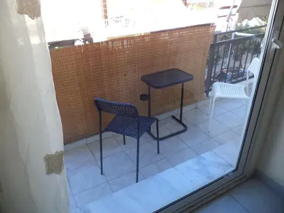 a balcony with two chairs and a table on a patio at Celia's in Athens