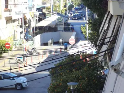 a view of a street with a white car on the road at Celia's in Athens