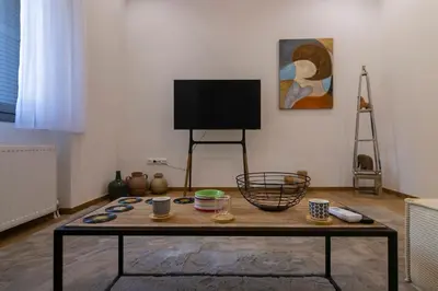 a living room with a coffee table and a flat screen tv at Timeless 1 bedroom Luxury at Panathenaic Stadium in Athens
