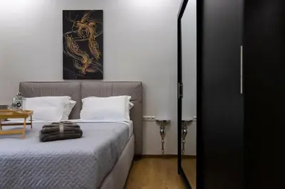 a bedroom with a bed with white pillows at Timeless 1 bedroom Luxury at Panathenaic Stadium in Athens