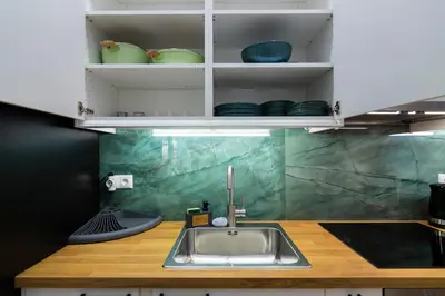 a kitchen with a sink and a counter top at Timeless 1 bedroom Luxury at Panathenaic Stadium in Athens