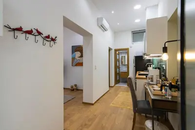 a kitchen with a table and chairs in a room at Timeless 1 bedroom Luxury at Panathenaic Stadium in Athens