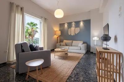 a living room with a couch and a table at Zen Vouliagmeni Beach Apartment 2 in Athens
