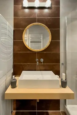 a bathroom with a white sink and a mirror at Zen Vouliagmeni Beach Apartment 2 in Athens