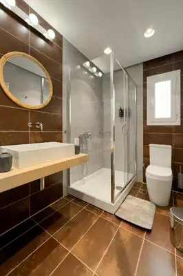 a bathroom with a shower and a toilet and a sink at Zen Vouliagmeni Beach Apartment 2 in Athens