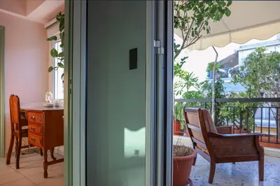 a door leading to a patio with a table and chairs at Adorable Jacuzzi flat in the most alive Athens! in Athens