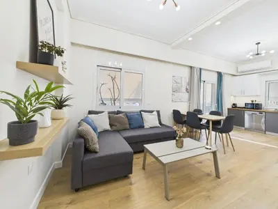 a living room with a couch and a table at KASO - Lontou Glyfada - 3 bed in Athens
