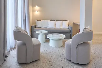 a living room with two chairs and a couch at Penthouse in the heart of Athens in Athens