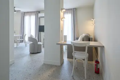 a living room with a table and chairs in a room at Penthouse in the heart of Athens in Athens