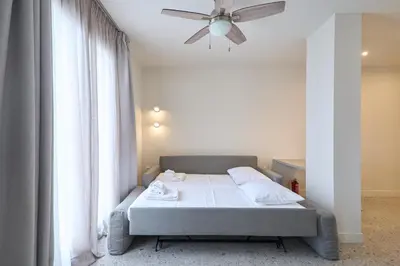 a bedroom with a bed and a ceiling fan at Penthouse in the heart of Athens in Athens