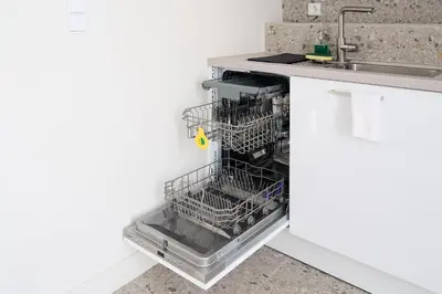 an empty dishwasher in a kitchen next to a sink at Penthouse in the heart of Athens in Athens
