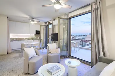 a living room with a couch and chairs and a balcony at Penthouse in the heart of Athens in Athens
