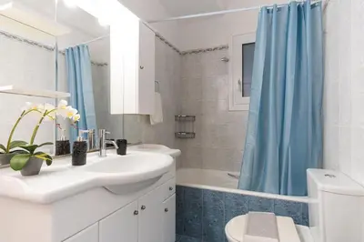 a bathroom with a sink and a toilet and a shower at Elegant 3 Bdr Apartment City Retreat in Kypseli in Mesochórion