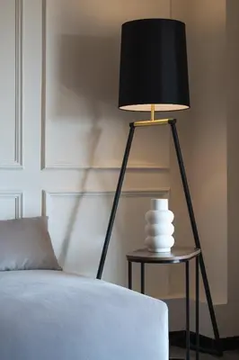 a black lamp sitting on a table next to a bed at Elegant 3 Bdr Apartment City Retreat in Kypseli in Mesochórion