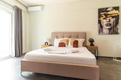 a bedroom with a large bed with towels on it at Elegant 3 Bdr Apartment City Retreat in Kypseli in Mesochórion