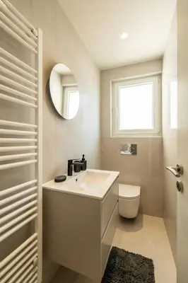 a bathroom with a sink and a toilet and a window at Stylish 2-Lvl maisonette near to Acropolis Museum in Athens