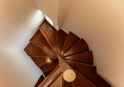 a wooden spiral staircase in a house at Stylish 2-Lvl maisonette near to Acropolis Museum in Athens