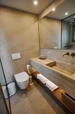 a bathroom with a tub and a toilet and a sink at By the Ellinikon in Athens