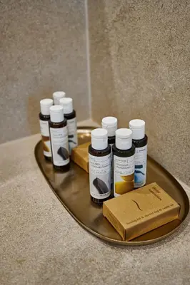 a tray with five bottles of honey on a counter at By the Ellinikon in Athens
