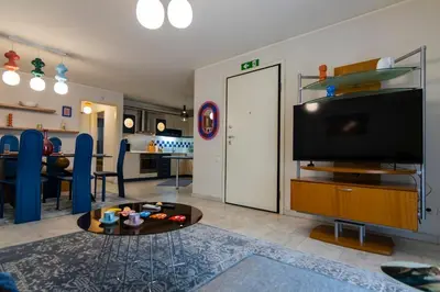 a living room with a television and a living room with a table at Blue Verve Premium 2 bedroom Retreat in Athens