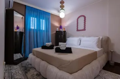 a bedroom with a large bed with towels on it at Blue Verve Premium 2 bedroom Retreat in Athens