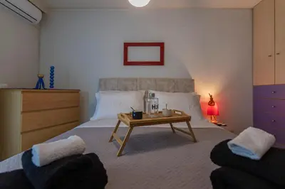 a bedroom with a bed with a coffee table in it at Blue Verve Premium 2 bedroom Retreat in Athens