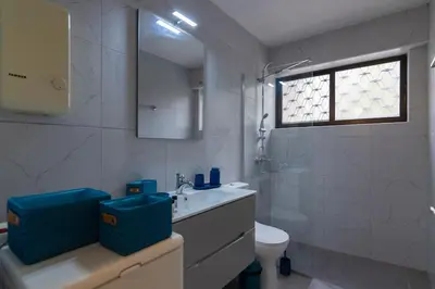 a white bathroom with a sink and a toilet at Blue Verve Premium 2 bedroom Retreat in Athens