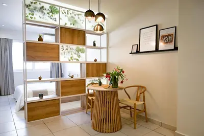 a room with a table with a vase of flowers on it at Omonia Flow One by ΜΡS in Athens