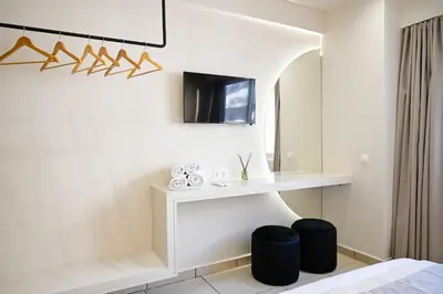 a bedroom with a bed and a desk and a mirror at Omonia Flow One by ΜΡS in Athens
