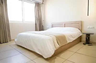 a bedroom with a bed with white sheets and a window at Omonia Flow One by ΜΡS in Athens