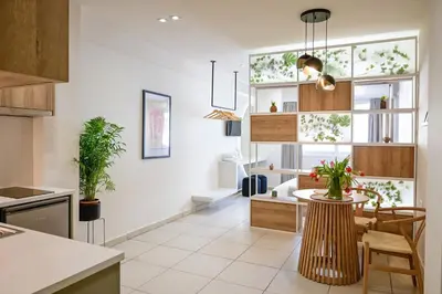 a kitchen with a table and some plants in it at Omonia Flow One by ΜΡS in Athens