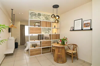 a living room with a table and a bed at Omonia Flow One by ΜΡS in Athens