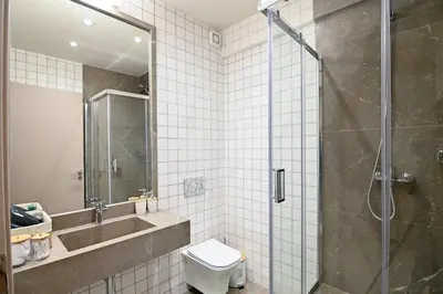 a bathroom with a shower and a toilet and a sink at Omonia Flow One by ΜΡS in Athens
