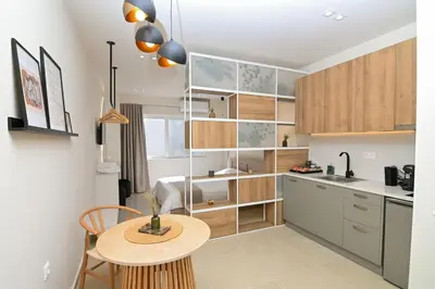 a small kitchen with a table and a counter at Omonia Flow Two by ΜΡS in Athens