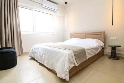 a bedroom with a large bed with a window and a window at Omonia Flow Two by ΜΡS in Athens